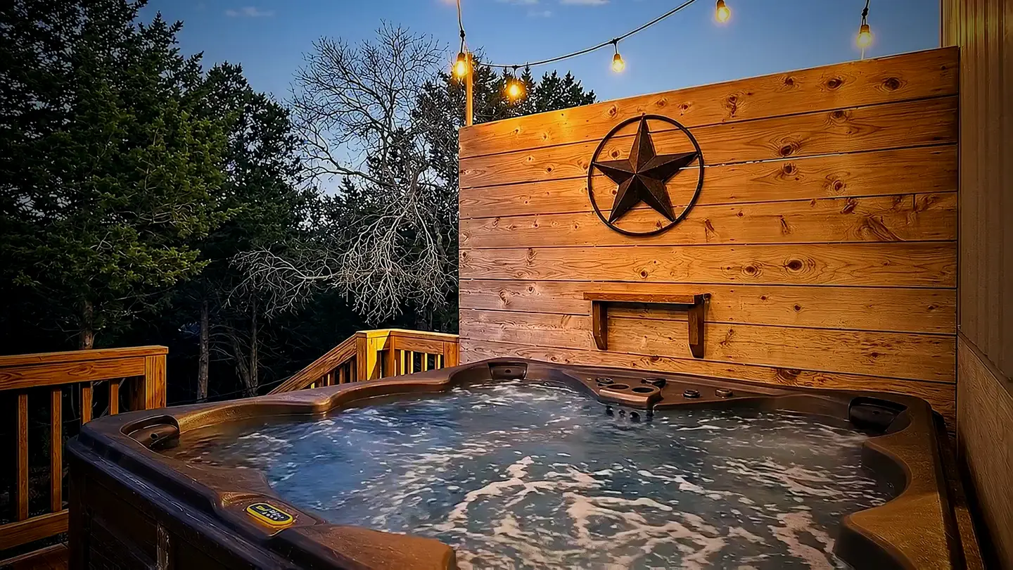 Hot tub on the string-lit deck at dusk